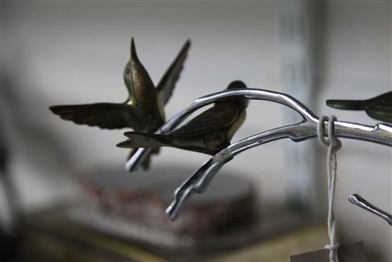 A French Art Deco silvered and painted bronze figure group, modelled as four humming birds, 13.75in.